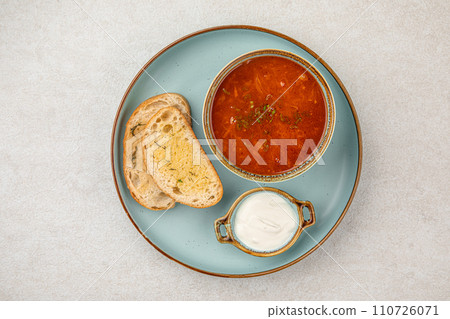 Portion of slavic traditional red soup borscht 110726071