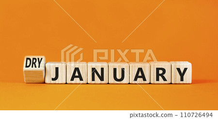 Dry January challenge symbol. Concept words Dry January on beautiful wooden cubes. Beautiful orange table orange background. Dry January healthy lifestyle concept. Copy space. 110726494