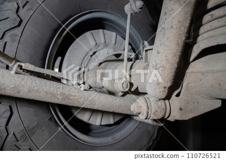 Rear suspension. View from below. SUV suspension in dust 110726521