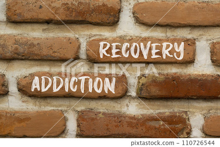 Addiction recovery symbol. Concept words Addiction recovery on beautiful brown brick wall. Beautiful brown brick wall background. Psychology addiction recovery concept. Copy space. 110726544