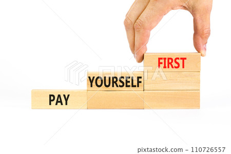Pay yourself first symbol. Concept words Pay yourself first on beautiful wooden blocks. Beautiful white table white background. Businessman hand. Business and pay yourself first concept. Copy space. Pay yourself first symbol. Concept words Pay yourself first on beautiful wooden blocks. Beautiful white table white background. Businessman hand. Business and pay yourself first concept. Copy space. 110726557
