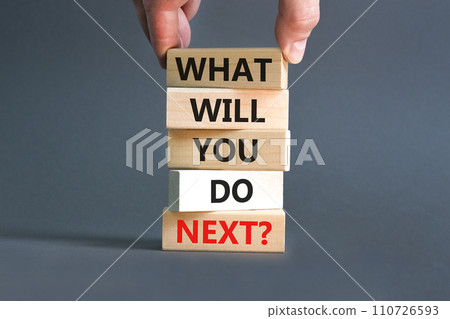 What will you do next symbol. Concept words What will you do next on wooden blocks. Beautiful grey table grey background. Businessman hand. Business, what will you do next concept. Copy space. 110726593