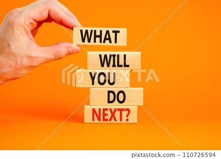 What will you do next symbol. Concept words What will you do next on wooden blocks. Beautiful orange table orange background. Businessman hand. Business, what will you do next concept. Copy space. 110726594