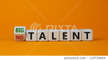 Turned a cube and changed words 'no talent' to 'big talent'. Beautiful orange background. Concept. Copy space. Turned a cube and changed words 'no talent' to 'big talent'. Beautiful orange background. Concept. Copy space. 110726604