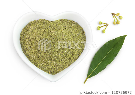 Fresh and ground Laurel leaves in ceramic bowl isolated on white background. Green bay leaf. Top view. Flat lay. Fresh and ground Laurel leaves in ceramic bowl isolated on white background. Green bay leaf. Top view. Flat lay. 110726972