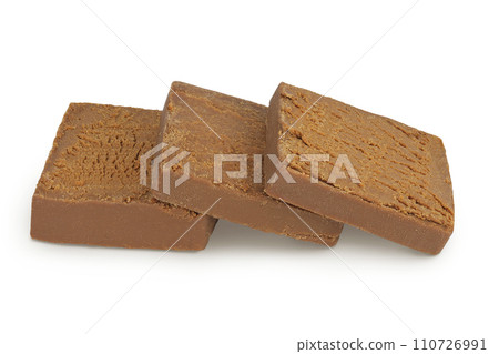 Brown cheese. Norwegian brunost isolated on white background with full depth of field 110726991