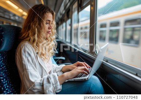 Mobile Office: Caucasian Woman on a Train with Laptop 110727048