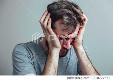 Heartache Revealed: A Man in Agony on a Light Gray Canvas 110727439