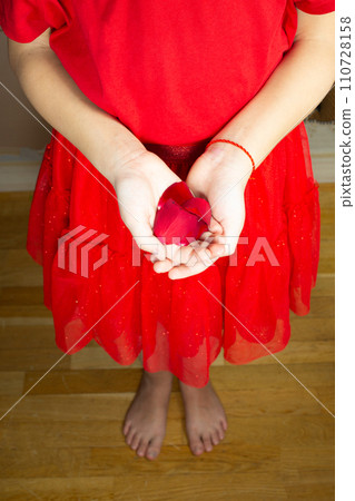 Girls hands holding a rose flower, woman first period health and gynecology . Menarche. First period party 110728158