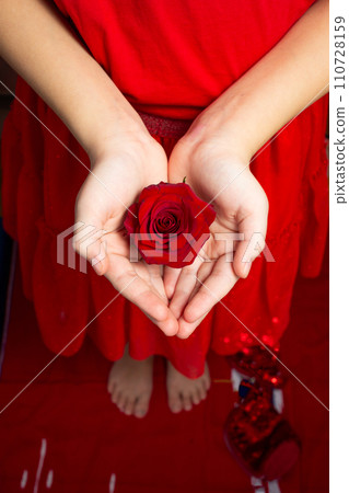 Girls hands holding a rose flower, woman first period health and gynecology . Menarche. First period party 110728159