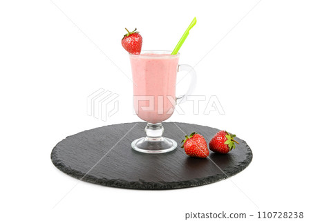Glass with strawberry smoothie on a slate tray isolated on white. Glass with strawberry smoothie on a slate tray isolated on white. 110728238