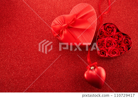 Gift box with beautiful red ribbon and roses, concept of Valentine's, anniversary, mother's day Gift box with beautiful red ribbon and roses, concept of Valentine's, anniversary, mother's day 110729417