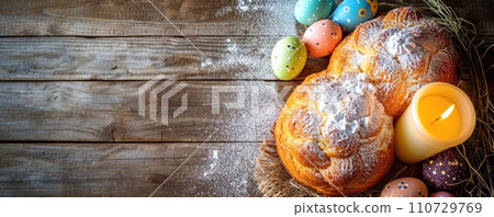 Colorful eggs and Easter cake with candle. Top view. Banner 110729769