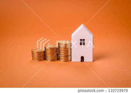 A small wooden house and keys as an idea for investing in your own home A small wooden house and keys as an idea for investing in your own home 110729970