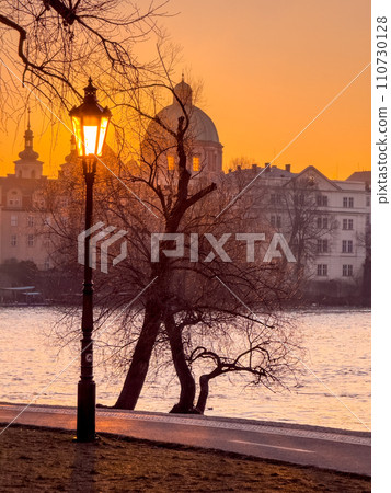 Prague bridge over a river with a city in the background 110730128