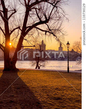 Prague bridge over a river with a city in the background 110730129