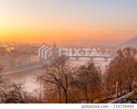 Prague bridge over a river with a city in the background Prague bridge over a river with a city in the background 110730494