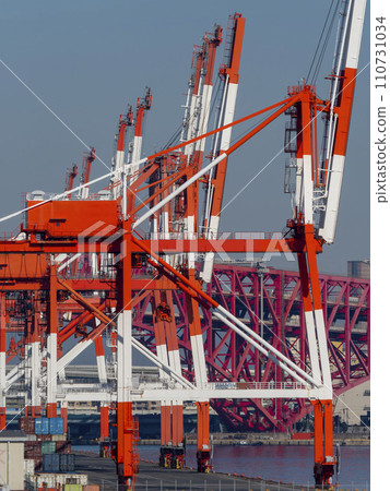Gantry cranes lined up at a container terminal Gantry cranes lined up at a container terminal 110731034
