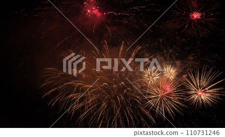 Impressive fireworks with flying sparks and smoke in dark evening sky. Festive fireworks dazzling display for party visitors at night. Flash patterns glows at fireworks shoe in dark sky Impressive fireworks with flying sparks and smoke in dark evening sky. Festive fireworks dazzling display for party visitors at night. Flash patterns glows at fireworks shoe in dark sky 110731246