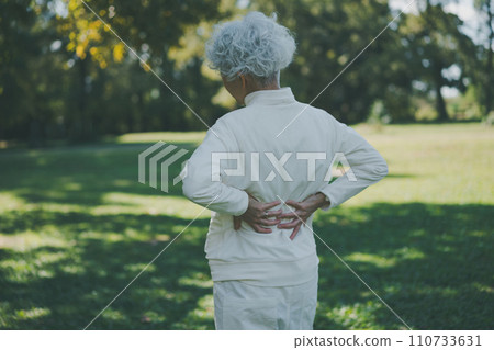 Senior with back pain after exercising Senior with back pain after exercising 110733631