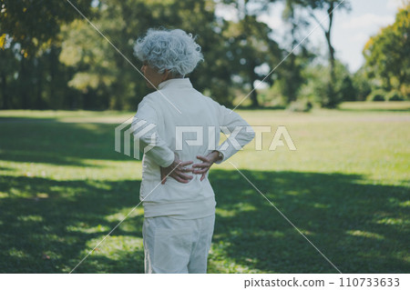 Senior with lower back pain after exercising Senior with lower back pain after exercising 110733633