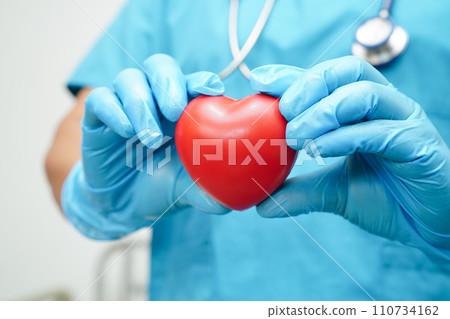 Asian woman doctor holding red heart for health in hospital. 110734162