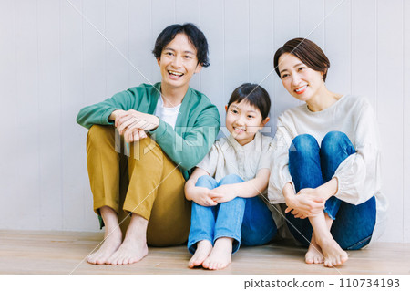 Close family sitting on the living room floor Close family sitting on the living room floor 110734193
