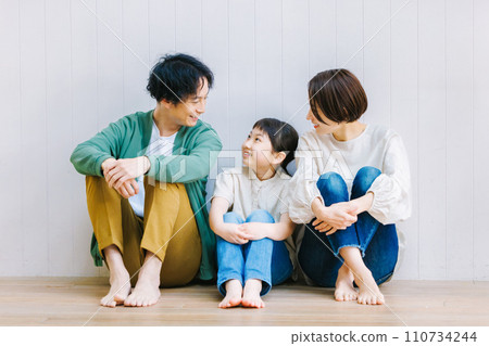Close family sitting on the living room floor Close family sitting on the living room floor 110734244
