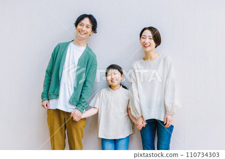 A close family holding hands in the living room A close family holding hands in the living room 110734303
