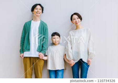 A close family holding hands in the living room A close family holding hands in the living room 110734326