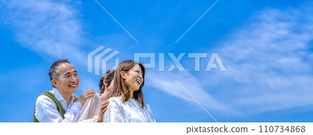A young woman and a middle-aged couple standing in a row A young woman and a middle-aged couple standing in a row 110734868