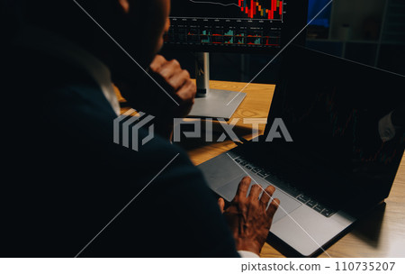 Thoughtful focused successful caucasian male stock investor, broker, financial adviser, sits at work desk, looks at computer, pensively analyze risks and prospects, rise or fall of cryptocurrency coin 110735207
