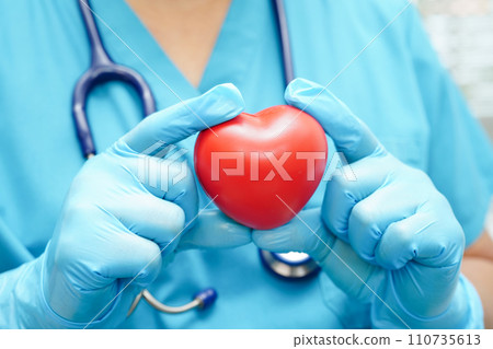 Asian woman doctor holding red heart for health in hospital. 110735613