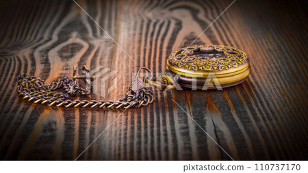 Antique pocket watch lying on old wooden background 110737170
