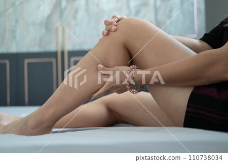 Female hands holding leg calves. Leg pain. Squeeze and massage to relax. Female hands holding leg calves. Leg pain. Squeeze and massage to relax. 110738034