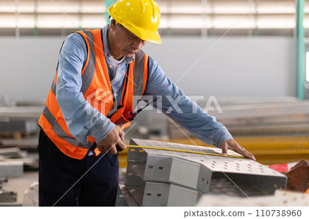 Construction engineer builder install perforated tray metal wireway cable duct rail in large industry building. 110738960