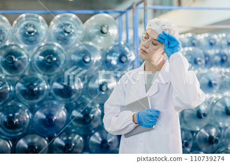 adult women brake relax work in food and drink factory drinking water plant worker tired exhausted gesture. adult women brake relax work in food and drink factory drinking water plant worker tired exhausted gesture. 110739274