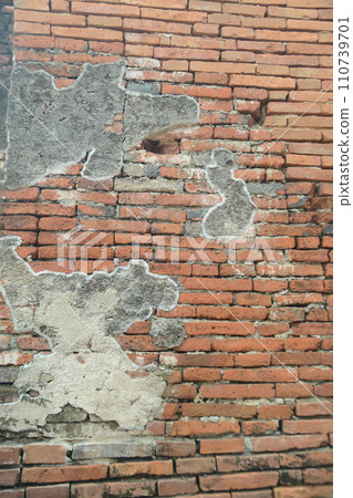 Old Brick Wall Texture Background with Peeling White Paint. Exterior Heritage Building Grunge Red Stonewall Facade With Damaged Plaster. Abstract Crack Wall Surface. Old Brick Wall Texture Background with Peeling White Paint. Exterior Heritage Building Grunge Red Stonewall Facade With Damaged Plaster. Abstract Crack Wall Surface. 110739701