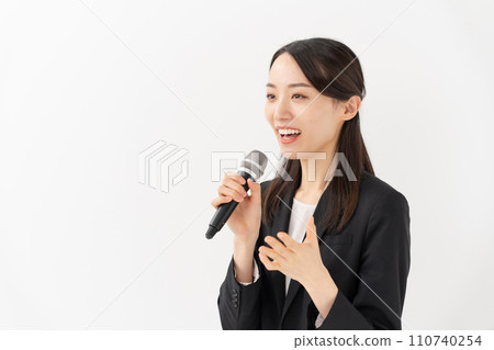 Business woman talking with a microphone Business woman talking with a microphone 110740254