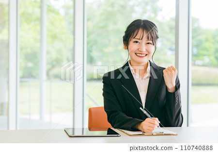 A young business woman doing a fist pump (counseling, qualifications, career improvement) A young business woman doing a fist pump (counseling, qualifications, career improvement) 110740888