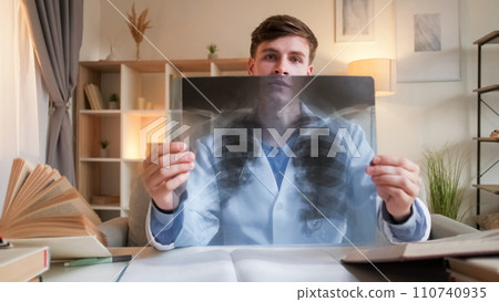 Radiology doctor. Medical diagnosis. Professional healthcare. Serious physician man with lung x ray film consulting on pneumonia at hospital workspace. 110740935