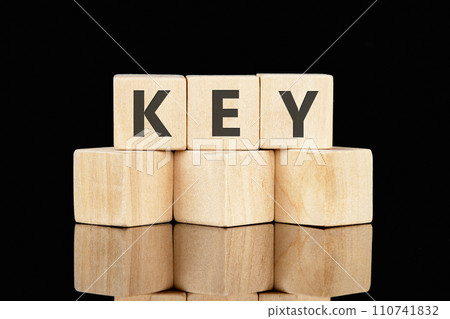 KEY text assembled from wooden cubes on a black background 110741832
