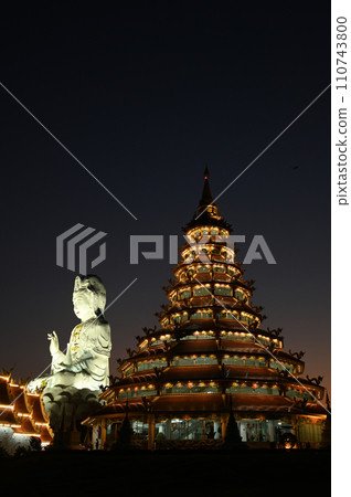 Scene of night time of Buddhist pagoda and Guan Yin Bodhisattva Statue the largest in Thailand at Wat Hua Pla Kang temple. Located at Chiang Rai Province in Thailand. 110743800