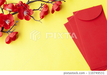 Top view of Chinese New Year red packet and cherry blossom with customizable space for text or wishes 110749531