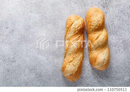 Bread, white baguette, top view Bread, white baguette, top view 110750511