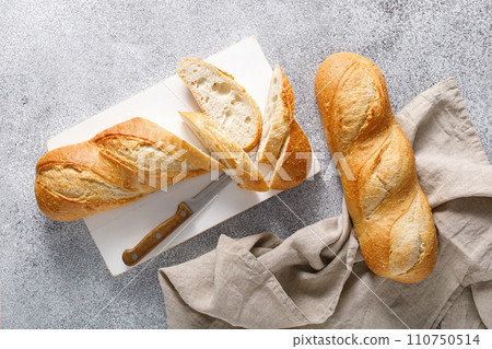 Bread, baguette sliced on a board, top view 110750514