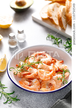 Shrimps with rosemary and lemon on a plate. Healthy food, seafood Shrimps with rosemary and lemon on a plate. Healthy food, seafood 110750549