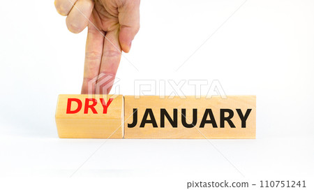 Dry January challenge symbol. Concept words Dry January on beautiful wooden cubes. Beautiful white table white background. Businessman hand. Dry January healthy lifestyle concept. Copy space. Dry January challenge symbol. Concept words Dry January on beautiful wooden cubes. Beautiful white table white background. Businessman hand. Dry January healthy lifestyle concept. Copy space. 110751241