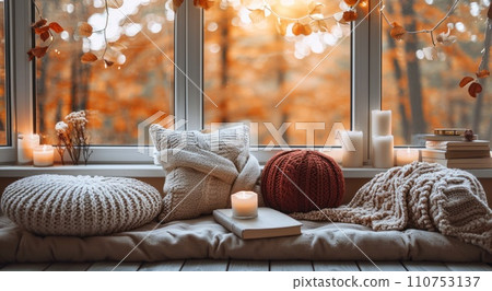 a window with pillows, books and candles a window with pillows, books and candles 110753137