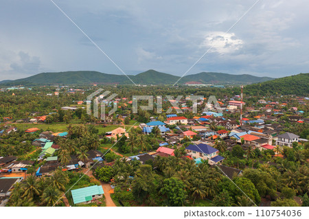 Aerial top view of Samet Nangshe, Phang Nga with city town, lush green trees from above in tropical forest in national park in summer season. Natural landscape. Pattern texture background. 110754036